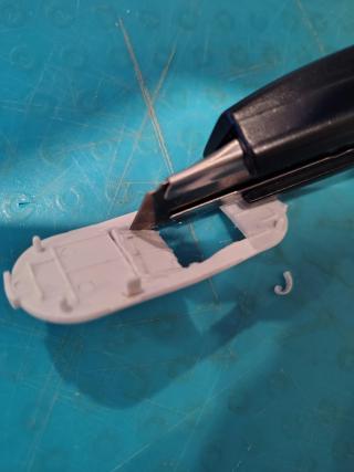 Modifying the enclosure to fit the new microcontroller. In retrospect, an x-acto knife was the wrong tool for the job here. 
