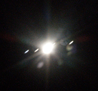 Jupiter shining brightly with four dots: the galilean moons!