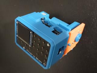 The PiFinder's 3D printed case, which wasn't designed for my scavenged battery pack and has clearly been melted with a soldering iron to expose important parts.