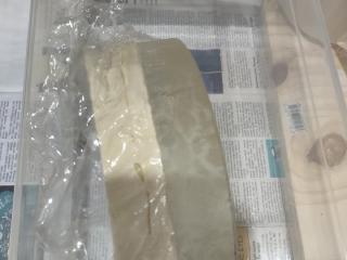 My poured dental stone tool, next to the mirror that gave it its shape! A layer of plastic wrap separates them.