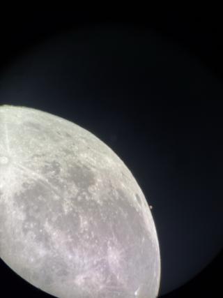 Mars, a tiny red dot with a hint of white ice cap visible, sits right next to the moon!