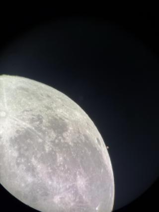 Mars, a tiny red dot with a hint of white ice cap visible, sits right next to the moon!