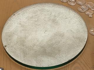 The same glass, viewed to catch the light and highlight dents in the glass or bubbles. Two big pits are circled. There are many ripples and a few very small pits, but nothing big!