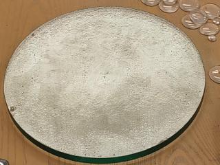 The same glass, viewed to catch the light and highlight dents in the glass or bubbles. Two big pits are circled. There are many ripples and a few very small pits, but nothing big!