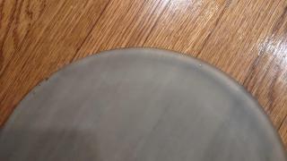A glass circle with a few divots