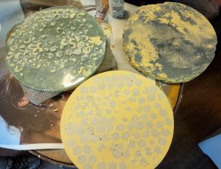 Top left: my mirror, after removing the new concave tool. Bottom: the freshly hardened concave tile tool made of dental stone and tiles. Top right: my old, too thin concave tool - notice the notches around the edge where crumbs kept breaking off during grinding attempts.