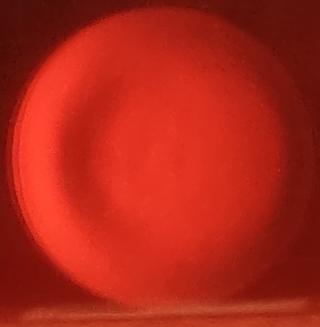 Another view of the mirror on may 3, this time very close to the mirror's focal point so the zones with different radii of curvature are more visible. If the mirror was a sphere it would be the same color the whole way through.